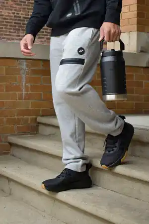 <div class="powerflex-label-bottoms">
Men's Bottoms <span class="powerflex-arrow-bottoms">›</span>
</div>
<style>
.powerflex-label-bottoms {
text-align: center;
background: #5A4743;
color: #ffffff;
font-weight: 700;
font-size: 16px;
padding: 12px 14px;
margin-top: 0;
cursor: pointer;
border-bottom: 4px solid #302E2D;
transition: all .2s ease;
}
.powerflex-label-bottoms:hover {
filter: brightness(90%);
}
.powerflex-arrow-bottoms {
display: inline-block;
margin-left: 7px;
font-size: 20px;
line-height: 1;
transition: transform .2s ease;
}
.powerflex-label-bottoms:hover .powerflex-arrow-bottoms {
transform: translateX(4px);
}
</style>
